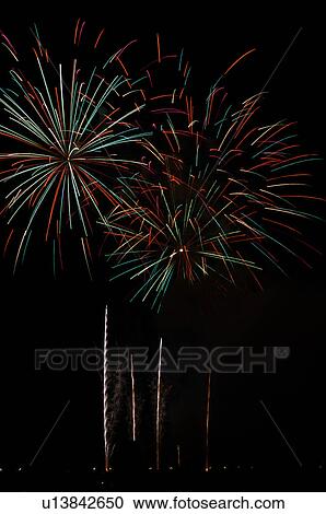 Fireworks exploding in the black night sky View Large Photo Image Stock Image - Fireworks exploding in the black night sky. Fotosearch