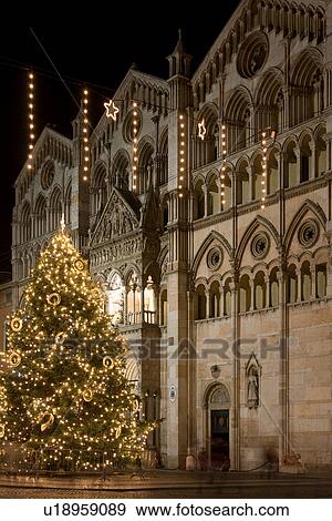 Stock Photo - Front of Duomo, Ferrara with Christmas tree, decorations and illumination. Fotosearch