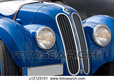 Front quarter view of blue antique BMW, showing hood, headlamps, grille and silver trim View Large Photo Image Stock Image - Front quarter view of blue antique BMW, showing hood, headlamps, grille and silver trim. Fotosearch