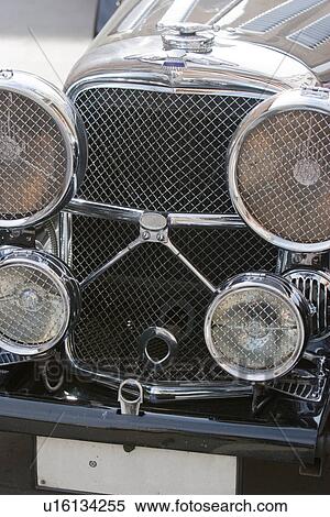 Stock Photography - Front view of black Jaguar showing hood, headlamps, and grille. Fotosearch