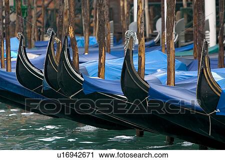 Gondolas moored at canal side in winter rain with blue covers View Large Photo Image Stock Image - Gondolas moored at canal side in winter rain with blue covers. Fotosearch