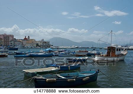 Harbour at Torre del Greco with boats moored, town and mountains in background, sunny summer day with blue sky and clouds View Large Photo Image Stock Photo - Harbour at Torre del Greco with boats moored, town and mountains in background, sunny summer day with blue sky and clouds. Fotosearch