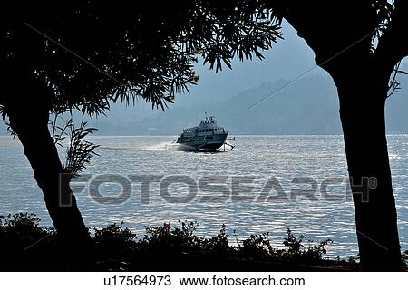 Hovercraft in motion on Lake Como, Italy, with trees silhouetted in foreground, in evening light View Large Photo Image Stock Image - Hovercraft in motion on Lake Como, Italy, with trees silhouetted in foreground, in evening light. Fotosearch