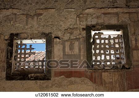 In the shadow of Vesuvius, the ruins of Ercolano - detail of house interior with frescoes and window grating View Large Photo Image Stock Image - In the shadow of Vesuvius, the ruins of Ercolano - detail of house interior with frescoes and window grating. Fotosearch