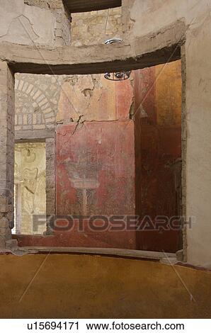 Stock Image - In the shadow of Vesuvius, the ruins of the Imperial Villa of Oplontis - detail of frescoes in guest rooms with architectural detail of curved window frame. Fotosearch