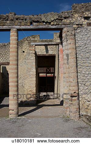 Stock Image - In the shadow of Vesuvius, the ruins of Ercolano - house of the wooden partition, view of peristyle. Fotosearch