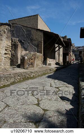 Stock Image - In the shadow of Vesuvius, the ruins of Ercolano - view of ancient road and Trellis house. Fotosearch