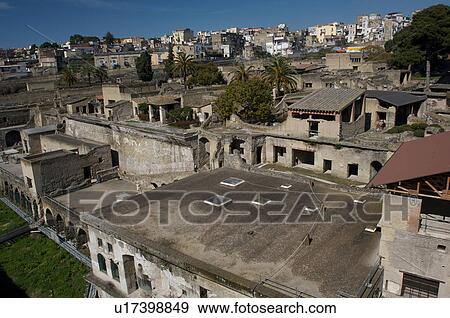 In the shadow of Vesuvius, the ruins of Ercolano - view of excavation site with modern town of Ercolano, and Vesuvius beyond View Large Photo Image Stock Photo - In the shadow of Vesuvius, the ruins of Ercolano - view of excavation site with modern town of Ercolano, and Vesuvius beyond. Fotosearch