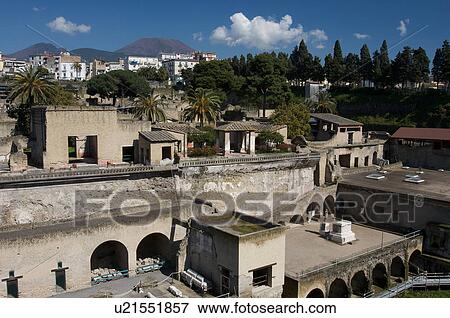 In the shadow of Vesuvius, the ruins of Ercolano - view of excavation site with modern town of Ercolano, and Vesuvius beyond View Large Photo Image Stock Photo - In the shadow of Vesuvius, the ruins of Ercolano - view of excavation site with modern town of Ercolano, and Vesuvius beyond. Fotosearch