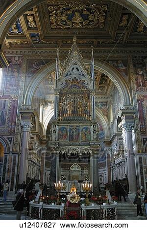 Interior view of San Giovanni in Laterano, Rome, Italy, with light streaming through windows onto central nave and altar, people in background View Large Photo Image Stock Photo - Interior view of San Giovanni in Laterano, Rome, Italy, with light streaming through windows onto central nave and altar, people in background. Fotosearch