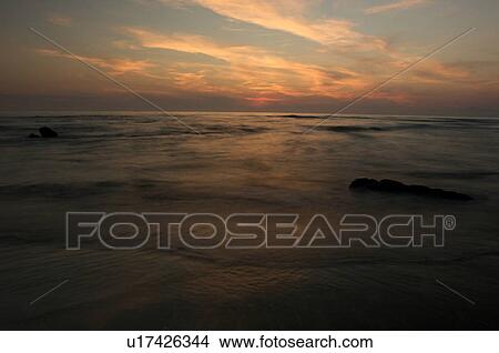 Italian beach at sunset, with motion blur of waves View Large Photo Image Picture - Italian beach at sunset, with motion blur of waves. Fotosearch