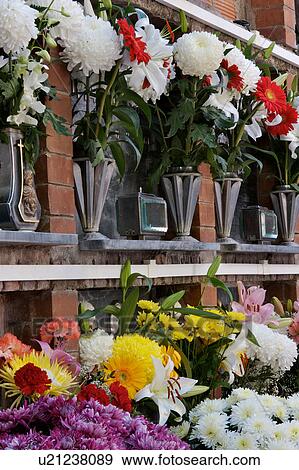 Stock Photo - Italian cemetery with rows of flowers at tombs. Fotosearch