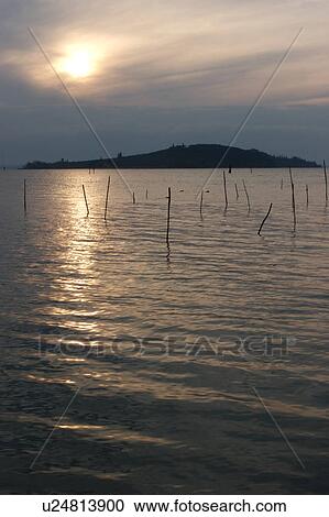 Stock Image - Lake Trasimeno view of island at sunset. Fotosearch