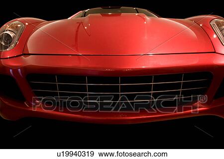Stock Photo - Low front view of red Ferrari, front view, hood, windscreen and grille. Fotosearch