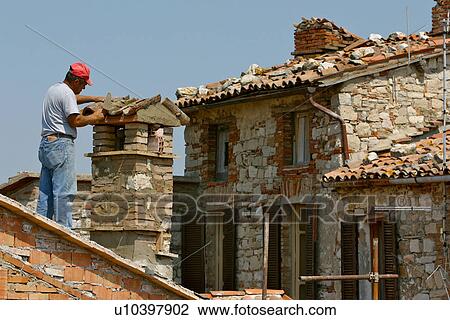 Man mending chimney on roof in medieval historic centre of town, Italy View Large Photo Image Stock Image - Man mending chimney on roof in medieval historic centre of town, Italy. Fotosearch