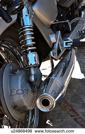 Stock Photo - Mechanical Detail of motorbike -suspension shock absorber and exhaust pipe. Fotosearch