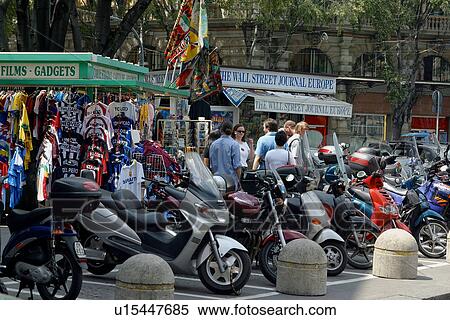 Stock Photography - Motorbikes parked in front of sidewalk stores. Fotosearch