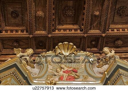Ornate painted and gilt wooden altarpiece detail, view from below, with coffered wooden ceiling, Bettona, Umbria View Large Photo Image Stock Image - Ornate painted and gilt wooden altarpiece detail, view from below, with coffered wooden ceiling, Bettona, Umbria. Fotosearch