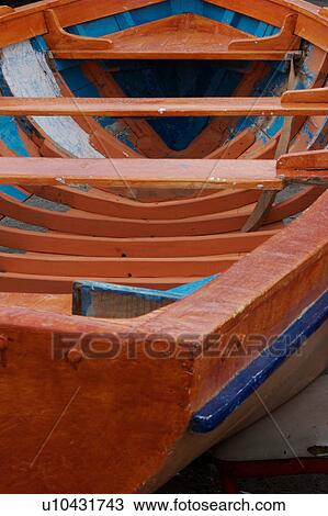 Stock Image - Painted orange and blue wooden fishing boat detail at Vietri sul Mare, South Italy. Fotosearch