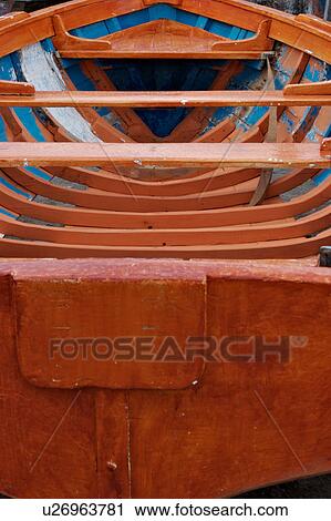 Stock Image - Painted orange and blue wooden fishing boat detail at Vietri sul Mare, South Italy. Fotosearch