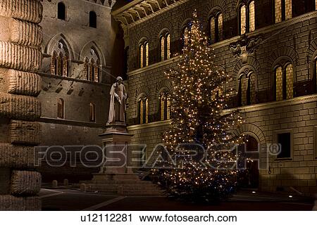 Stock Image - Palazzo Salimbeni with statue of Sallustio Bandini, Siena, Italy. Fotosearch