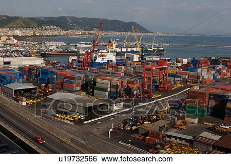 Stock Photograph - Port entry road, sea going shipping containers, and harbour, Salerno harbour, Italy. Fotosearch