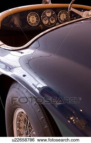 Stock Photograph - rear quarter detail of blue antique Ferrari convertible, showing dashboard and steering wheel,. Fotosearch