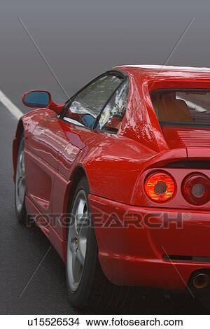 Rear quarter view of red ferrari on road in fog View Large Photo Image Picture - Rear quarter view of red ferrari on road in fog. Fotosearch
