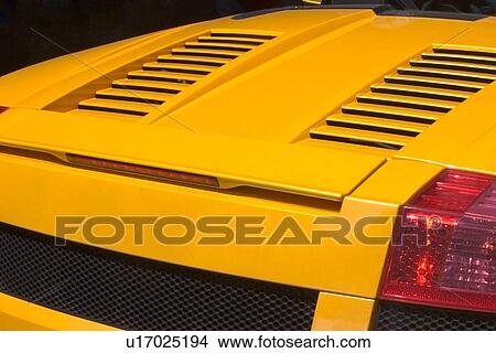 Rear view detail of yellow Lamborghini, with black rear grille and red tail lights View Large Photo Image Picture - Rear view detail of yellow Lamborghini, with black rear grille and red tail lights. Fotosearch