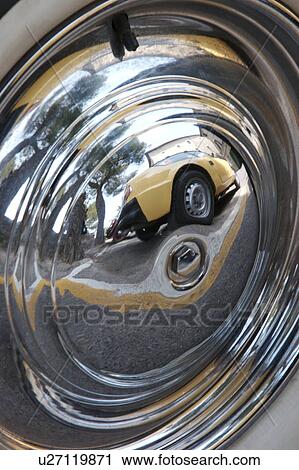 Reflection of antique yellow car and Italian castle, reflected in wheel hub of antique car View Large Photo Image Stock Image - Reflection of antique yellow car and Italian castle, reflected in wheel hub of antique car. Fotosearch