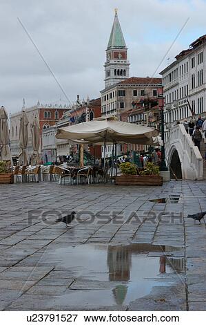 Stock Photo - Riva Schiavoni after rain with reflection of Campanile San Marco in Puddle. Fotosearch