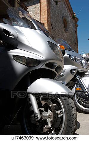 Row of BMW motorbikes showing front wheels, outside church Italy View Large Photo Image Stock Photo - Row of BMW motorbikes showing front wheels, outside church Italy. Fotosearch