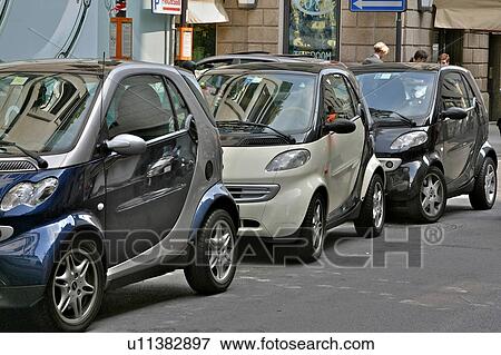 Row of Smart cars parked on shopping street, Milan, Italy View Large Photo Image Stock Photo - Row of Smart cars parked on shopping street, Milan, Italy. Fotosearch