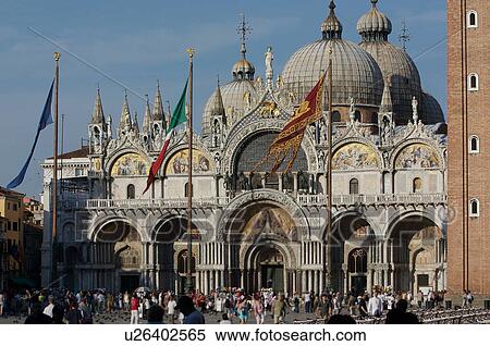 San Marco Basilica, Piazza San Marco with tourists and flags flying, edge of Campanile visible View Large Photo Image Stock Photography - San Marco Basilica, Piazza San Marco with tourists and flags flying, edge of Campanile visible. Fotosearch