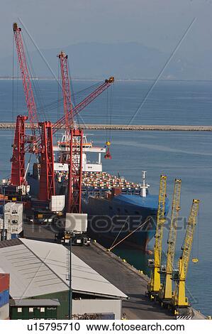 Stock Image - Sea going shipping containers, crane loading onto ship, Salerno harbour, Italy. Fotosearch