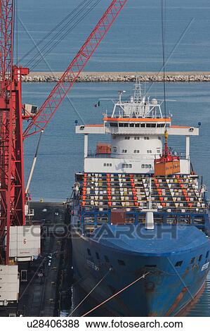 Stock Photo - Sea going shipping containers, crane loading onto ship, Salerno harbour, Italy. Fotosearch