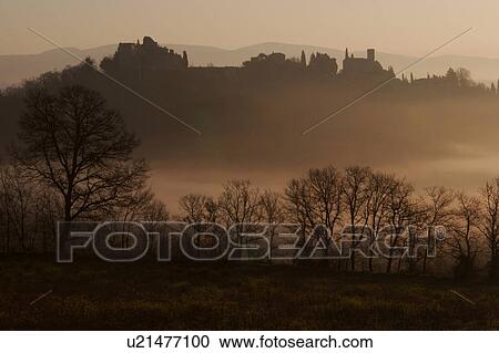 silhouette of medieval village in early morning winter mist, Tiber Valley, with bare trees in foreground View Large Photo Image Stock Image - silhouette of medieval village in early morning winter mist, Tiber Valley, with bare trees in foreground. Fotosearch