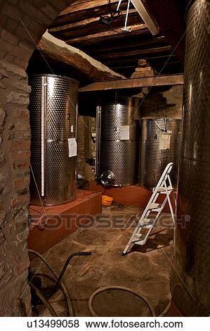 Stock Photo - Stainless steel vats for wine storage in cantina. Fotosearch