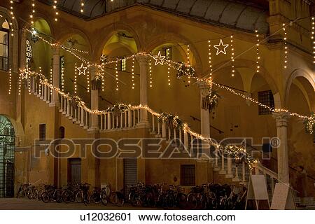 Stairway, inner courtyard of Palazzo Comunale, illuminated by Christmas lights, and bicycles parked below View Large Photo Image Stock Image - Stairway, inner courtyard of Palazzo Comunale, illuminated by Christmas lights, and bicycles parked below. Fotosearch
