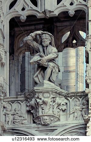 Stone sculpture detail of facade, seated figure with book, Milan cathedral View Large Photo Image Stock Image - Stone sculpture detail of facade, seated figure with book, Milan cathedral. Fotosearch