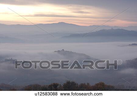 Sunrise over Tiber valley with grey pink and golden sky in the early morning mist of winter, with tree outline in foreground View Large Photo Image Stock Photo - Sunrise over Tiber valley with grey pink and golden sky in the early morning mist of winter, with tree outline in foreground. Fotosearch