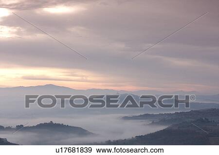 Sunrise over Tiber valley with grey pink and golden sky in the early morning mist of winter View Large Photo Image Stock Photo - Sunrise over Tiber valley with grey pink and golden sky in the early morning mist of winter. Fotosearch