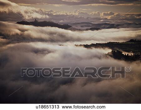 Tiber valley and Todi in swirling early morning cloud and mist View Large Photo Image Stock Image - Tiber valley and Todi in swirling early morning cloud and mist. Fotosearch