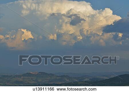 Stock Photograph - Tiber valley landscape with storm clouds and Todi in distance. Fotosearch