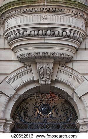 Upward view of ornate stonework over arched entrance with wrought iron fill in, Glasgow, Scotland View Large Photo Image Stock Image - Upward view of ornate stonework over arched entrance with wrought iron fill in, Glasgow, Scotland. Fotosearch