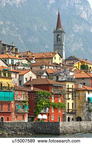 Varenna, view of harbour from water, church bell tower and mountain looming in background View Large Photo Image Stock Photo - Varenna, view of harbour from water, church bell tower and mountain looming in background. Fotosearch