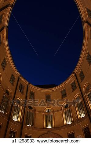 View looking up, Ferrara Theatre inner courtyard, with night sky above, illuminated circular building View Large Photo Image Stock Image - View looking up, Ferrara Theatre inner courtyard, with night sky above, illuminated circular building. Fotosearch