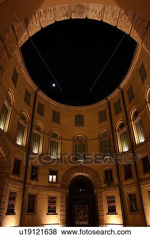View looking up, Ferrara Theatre inner courtyard, with moon and dark night sky above, illuminated circular building View Large Photo Image Stock Photo - View looking up, Ferrara Theatre inner courtyard, with moon and dark night sky above, illuminated circular building. Fotosearch