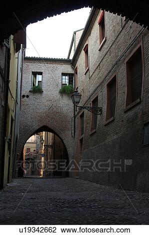Stock Image - view of 14th century street with Gothic arches and cobblestone paving. Fotosearch