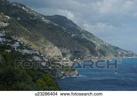 Picture - View of Amalfi coast, sea and coastline before storm, with cloudy sky and sun. Fotosearch